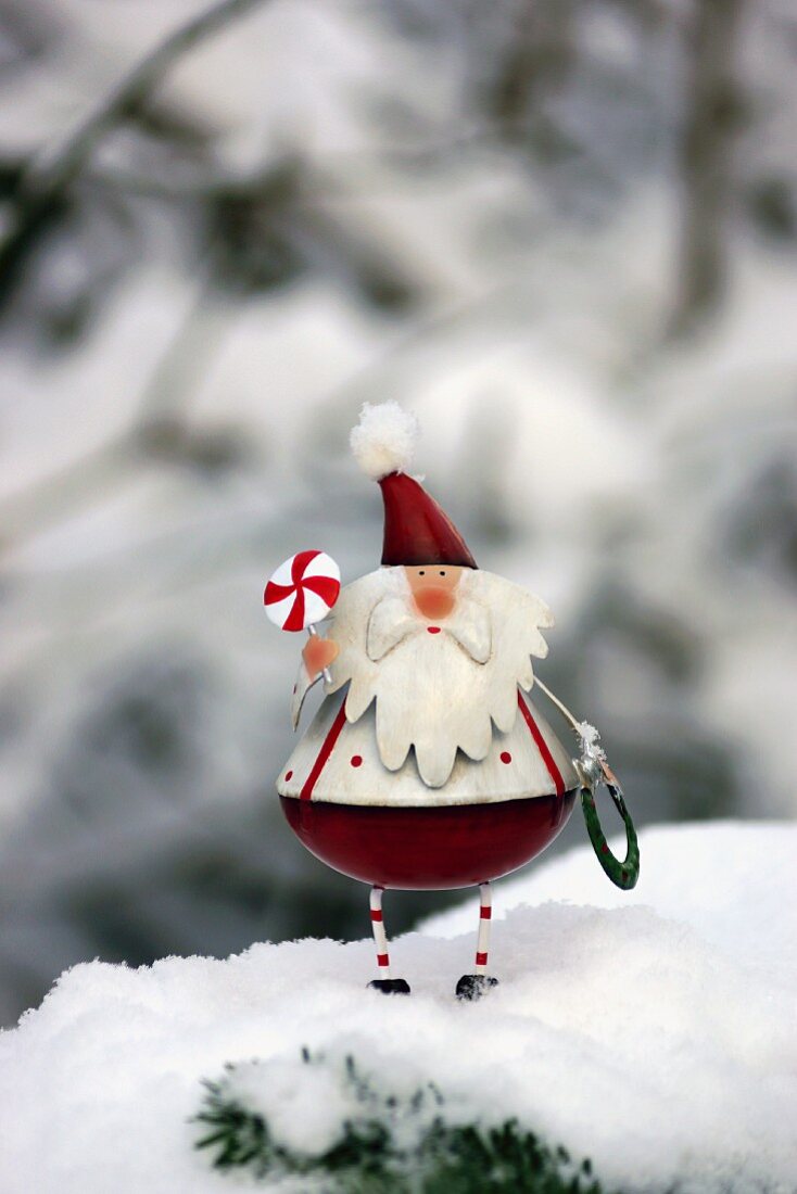 Father Christmas figurine in snow