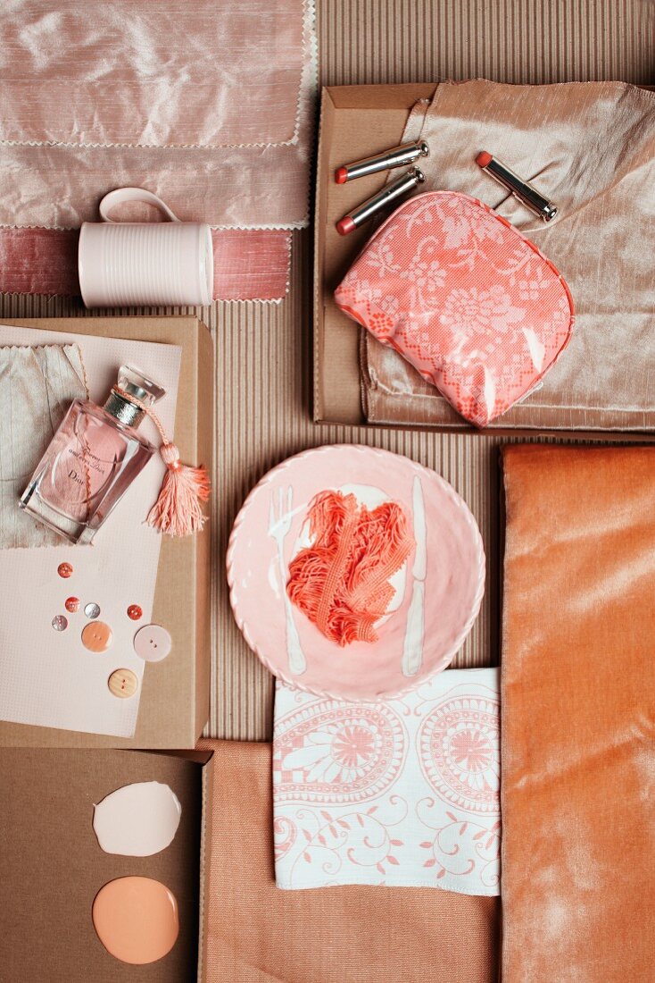 Arrangement of leather, silk and cosmetics in shades of powder pink