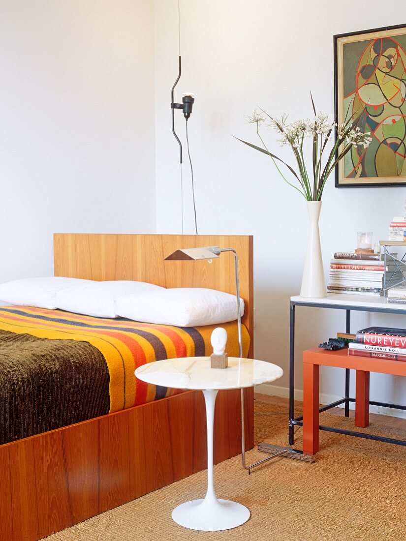 Bedroom with modern bed and Eero Saarinen side table