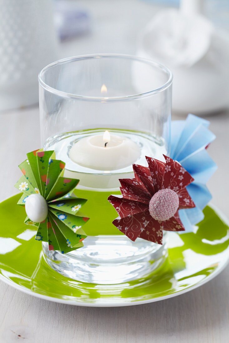 Colourful paper flowers with buttons as centres decorating candle lantern with floating lantern