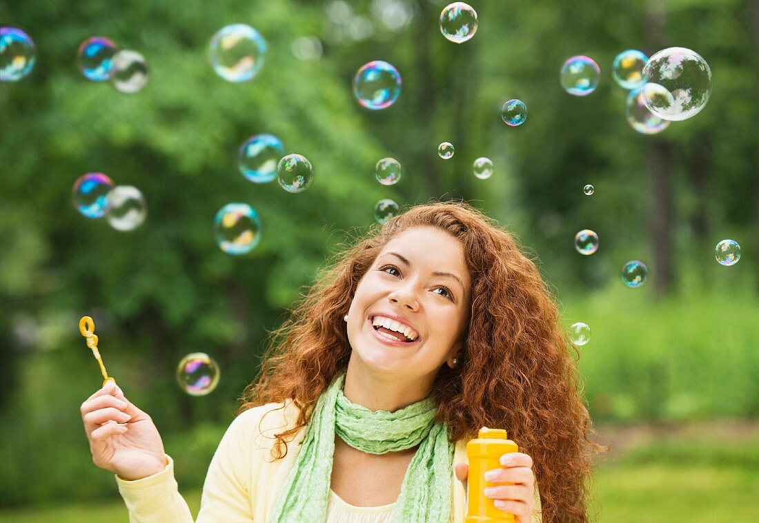 Woman blowing soap bubbles