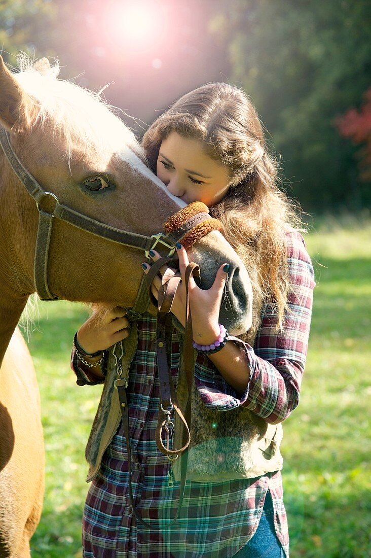 Girl and horse outdoors