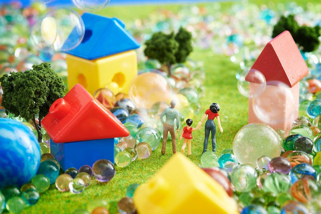 Toy landscape with figurines, houses and marbles