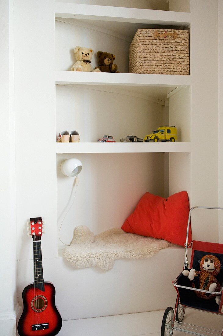 Toys on corner shelving and ukulele in child's bedroom