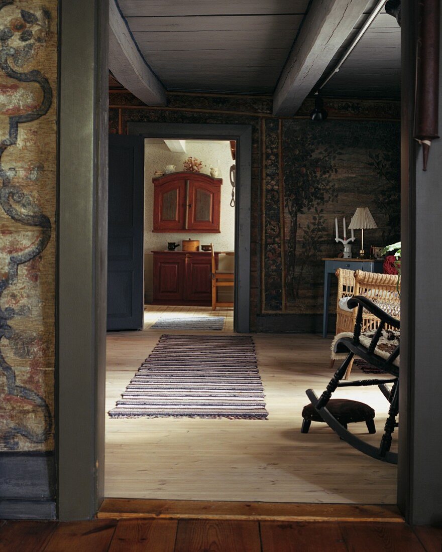 View through open door into simple living room of Scandinavian country house