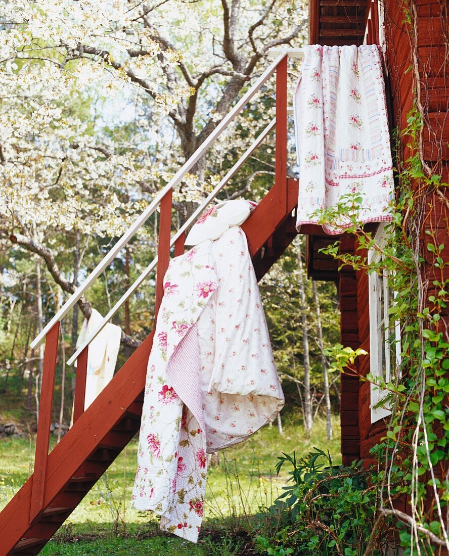 Bedclothing hanging on a stair rail