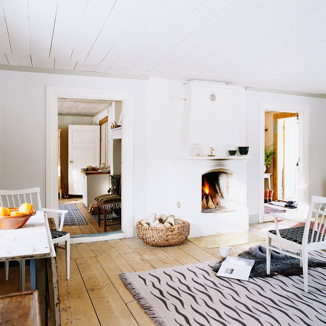 White, country-house interior with open fireplace