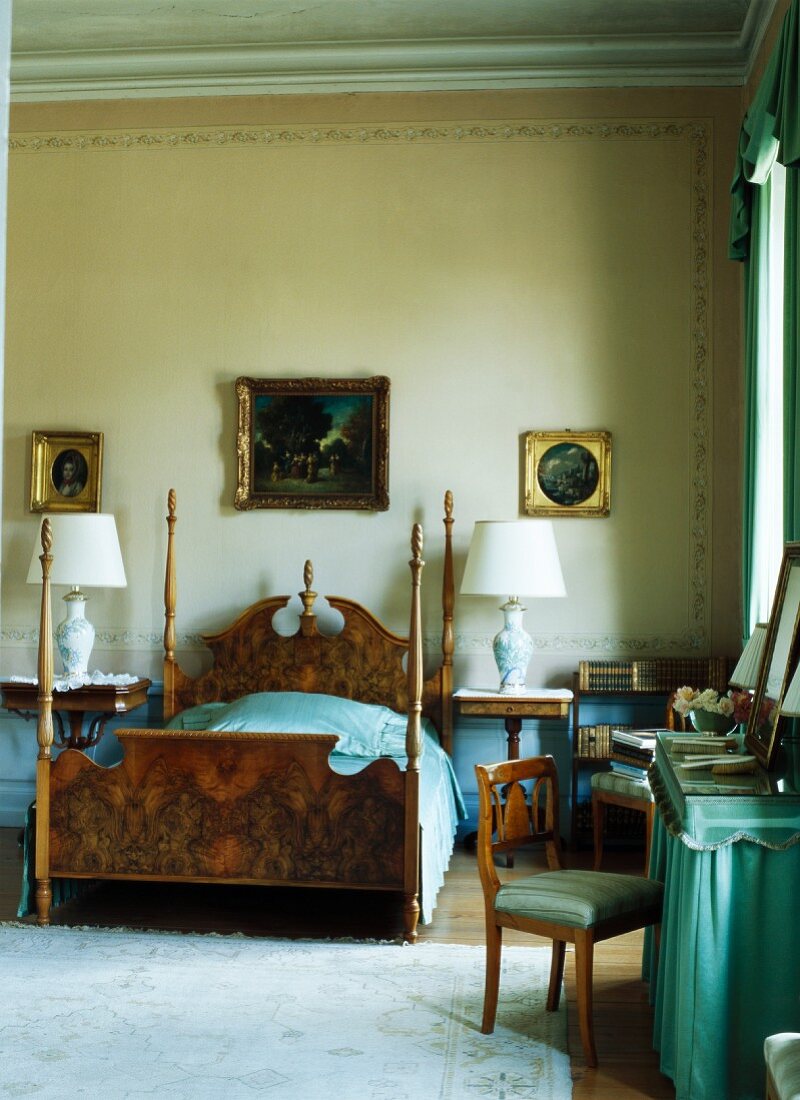 Antique bed with corner posts and dressing table in grand bedroom
