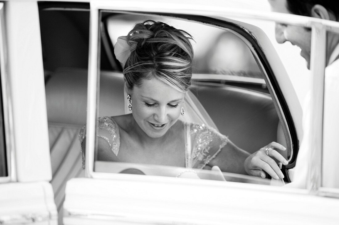Bride alighting from car
