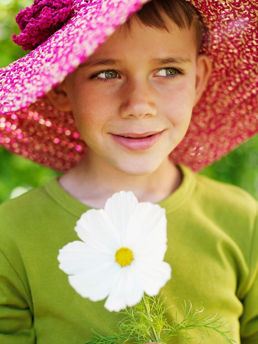 Portrait of a boy wearing a lady?s hat, Sweden.