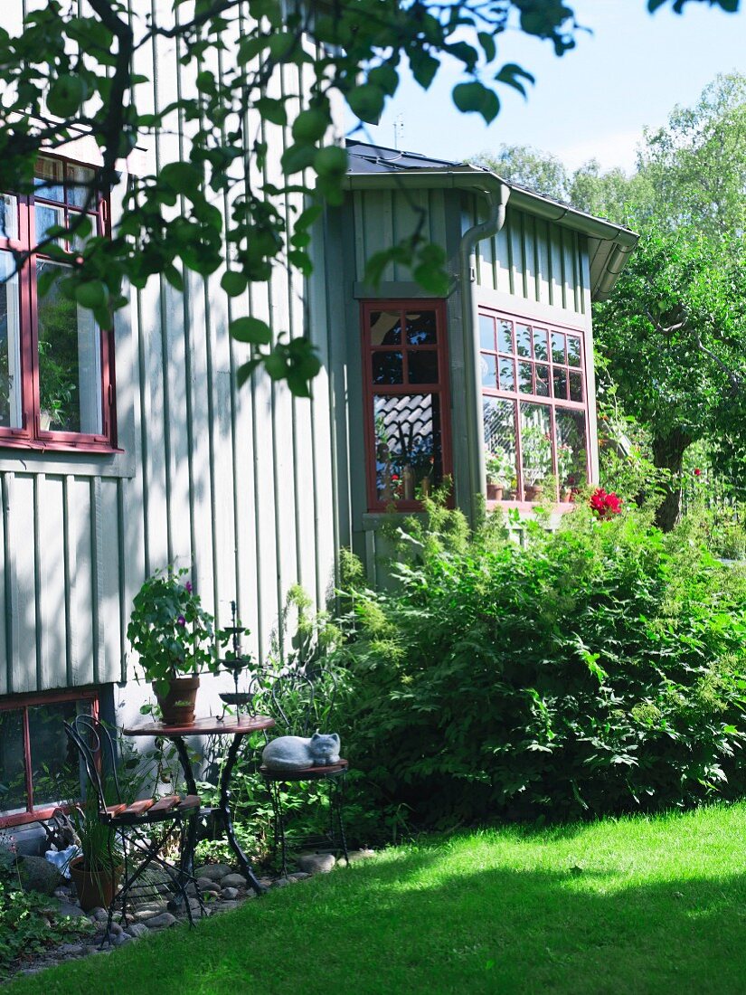 Gable of a green house in a garden, Sweden.