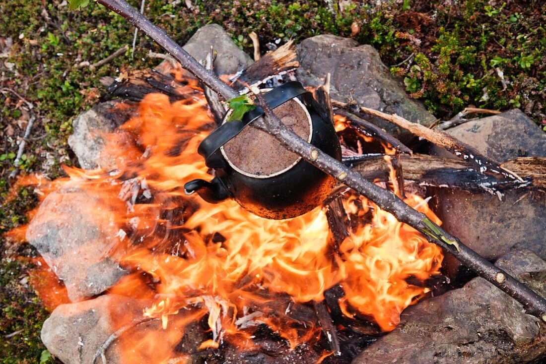 Kettle with coffee over campfire