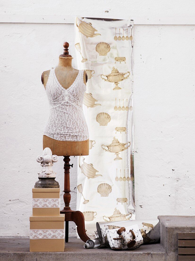 Lace top on old tailors' dummy; curtain with kitchen motifs in background