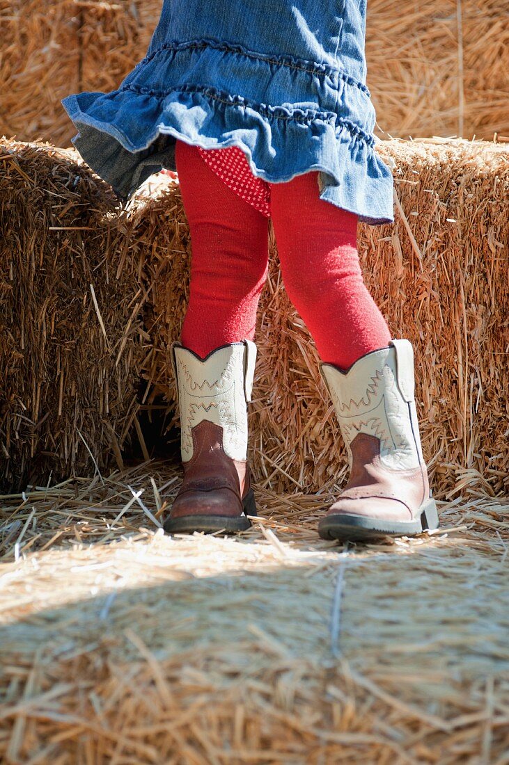 Female toddler with oversized boots
