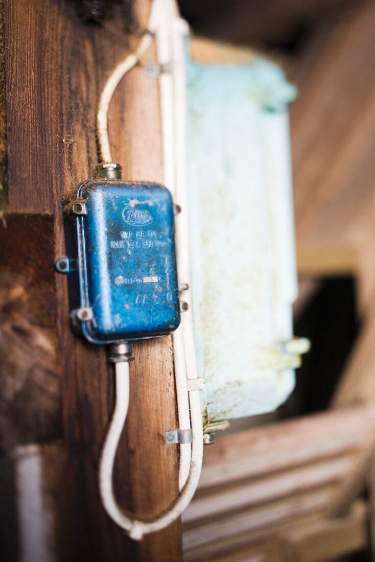 Close-up of simple electrical wiring on wooden wall