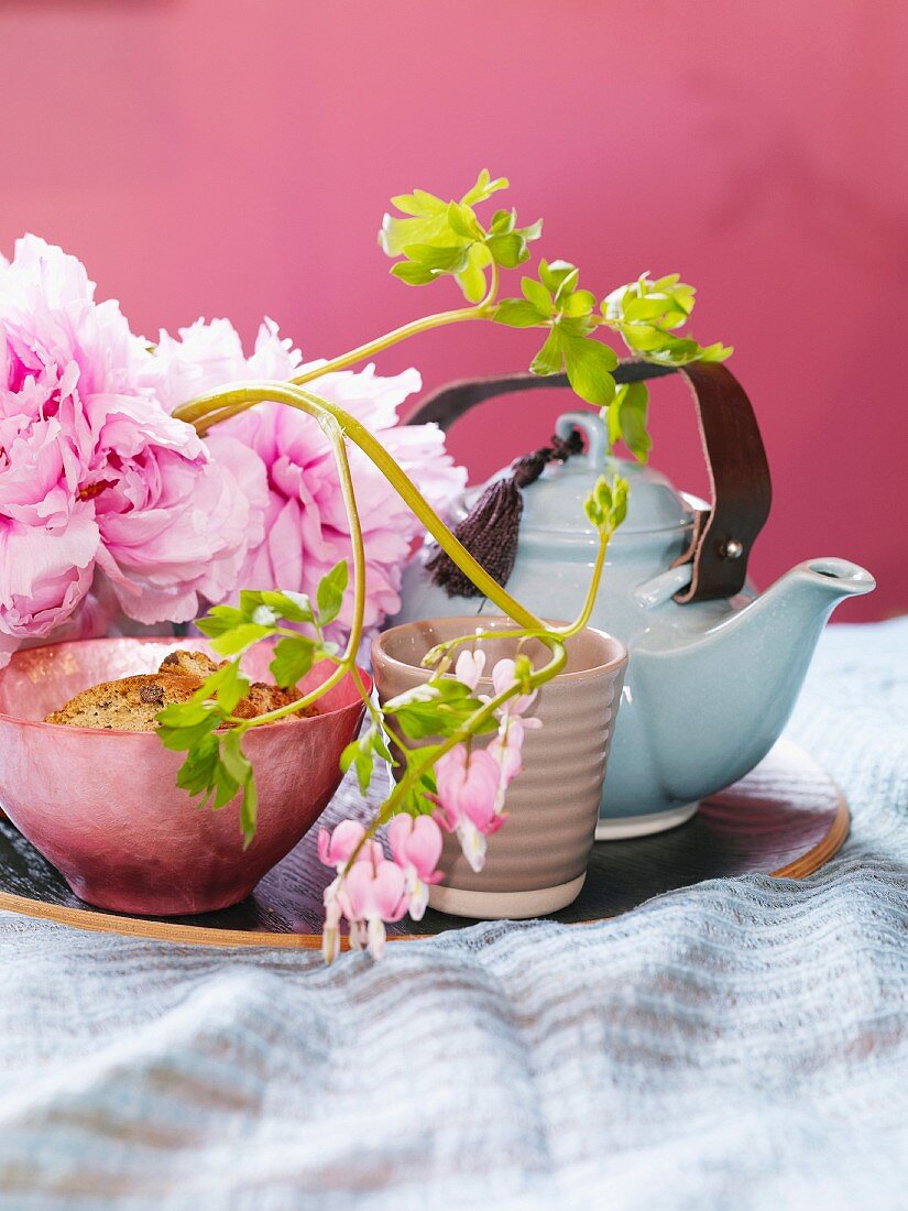 A teapot and flowers.