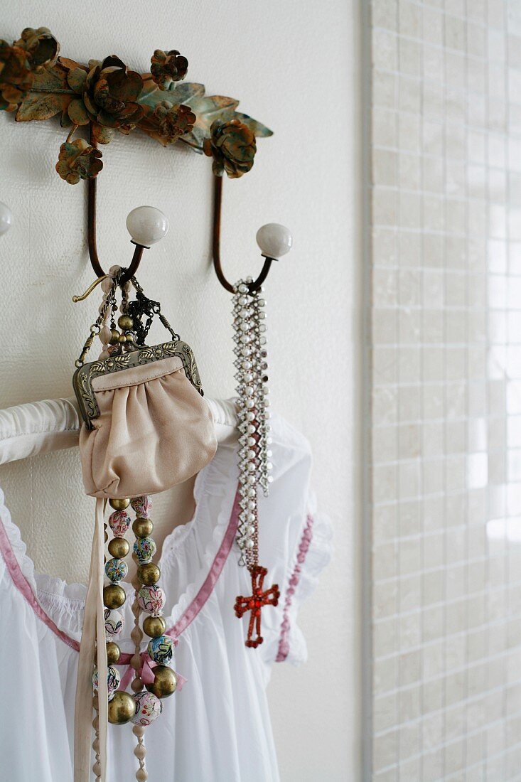 Pieces of jewellery hanging on a hook.