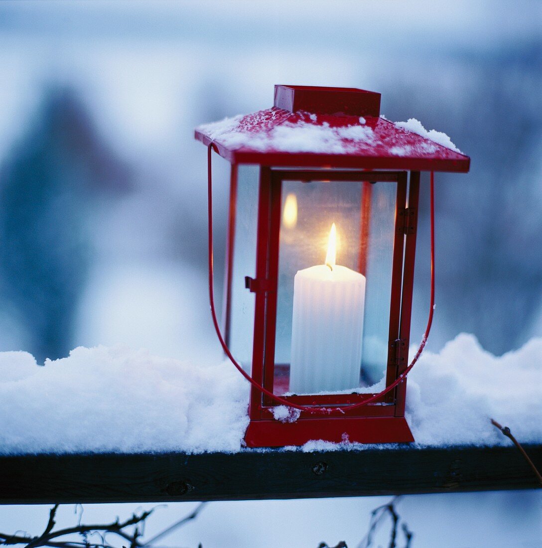 A lit candle in a lantern.