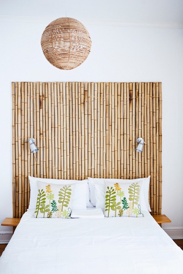 Double bed with headboard made from bamboo poles