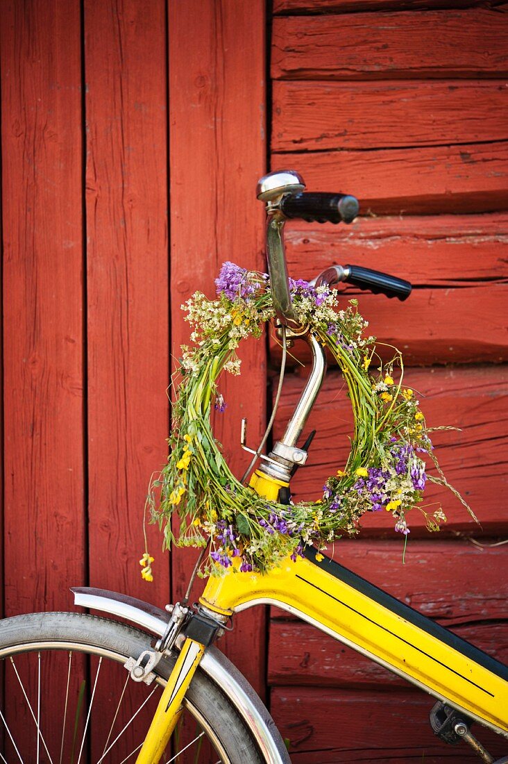Wreath of wild flowers on handlebars of bicycle