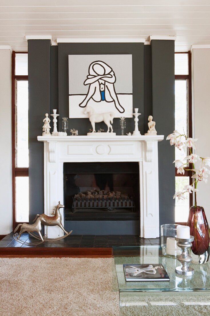 Modern artwork above traditional fireplace in classic, modern interior