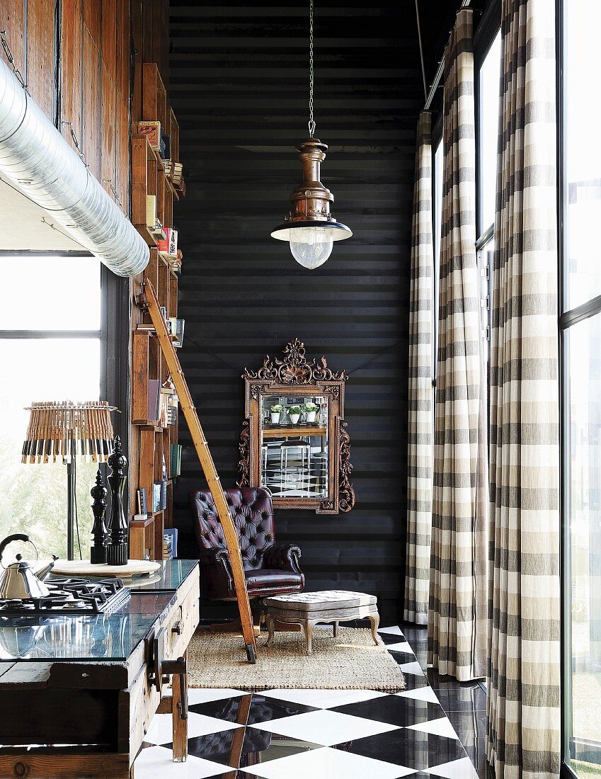 Steampunk loft apartment with reading corner next to bookcase