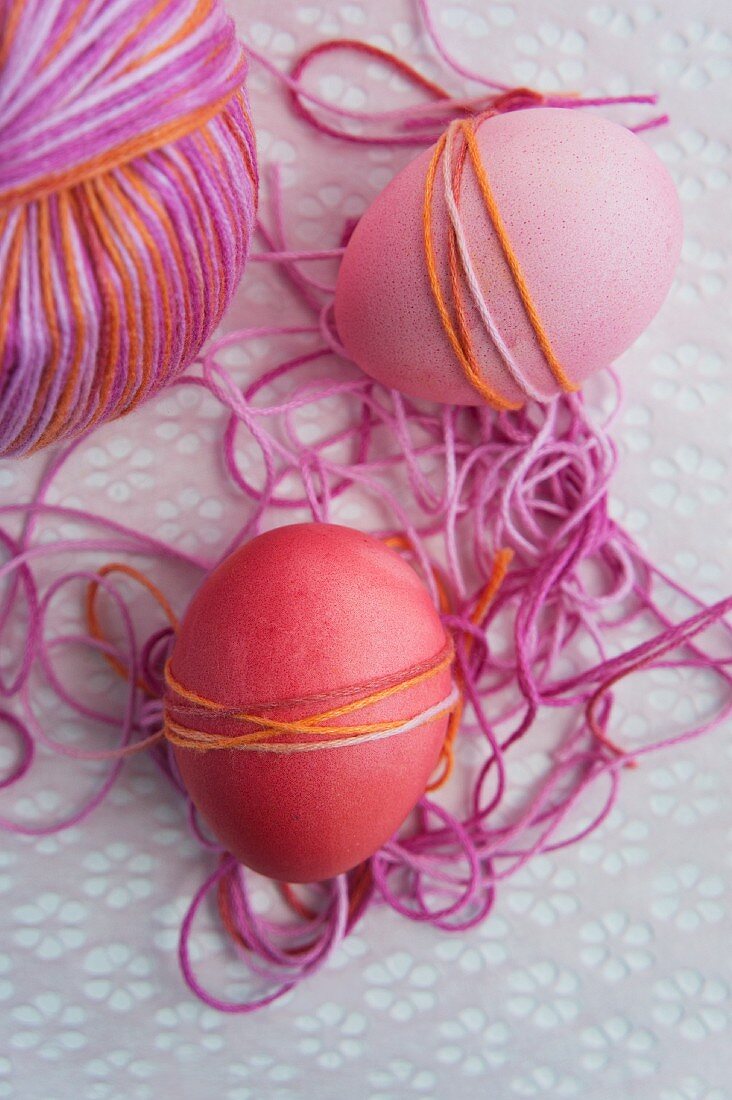Wrapping dyed Easter eggs with yarn
