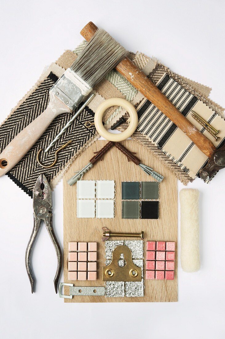 Still life arrangement of DIY objects and tools used to make a house shape