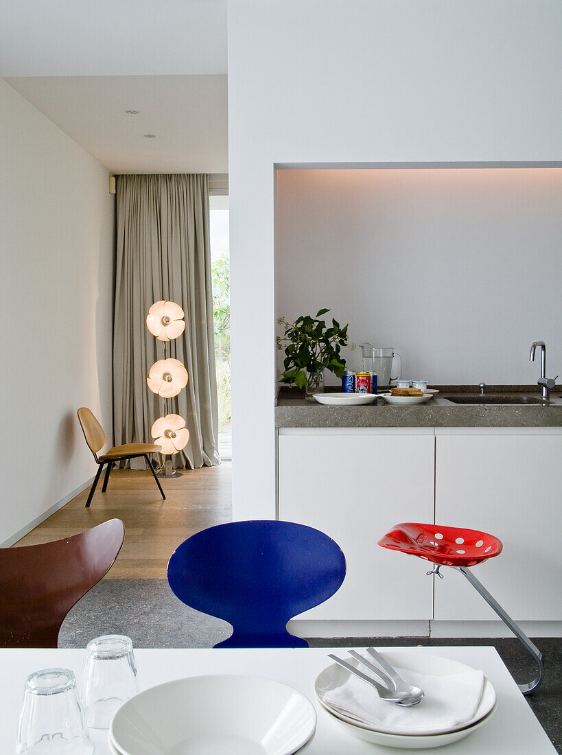 Kitchen with integrated dining area and colorful chairs