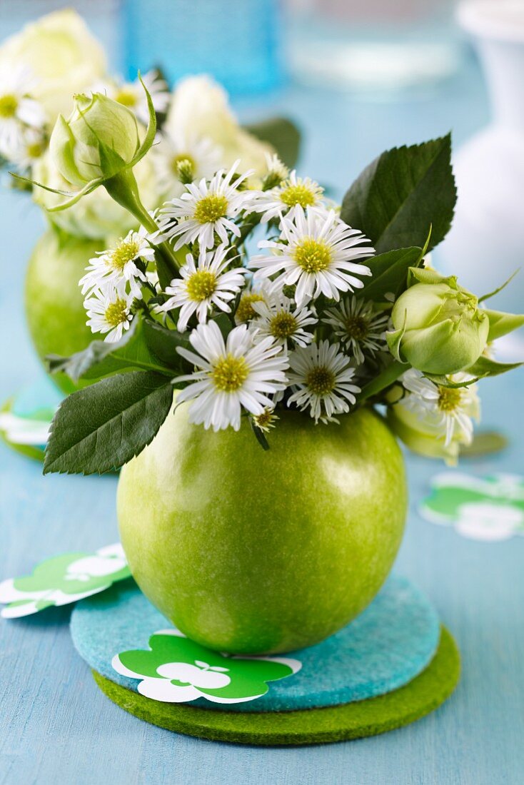 Green apple used as vase for posy