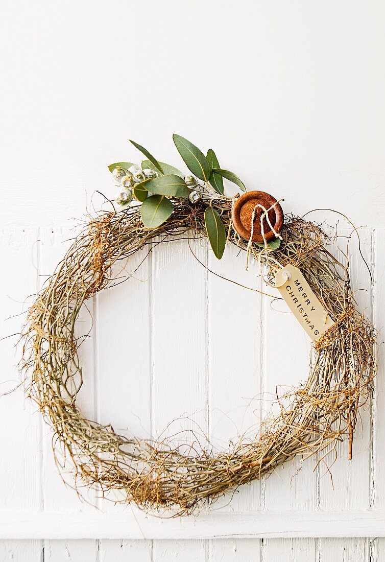 Simple wreath of branches on a white plank wall