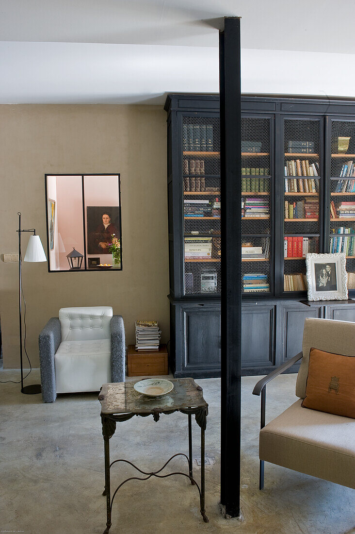 Reading corner with bookshelf, armchair and side table in living room