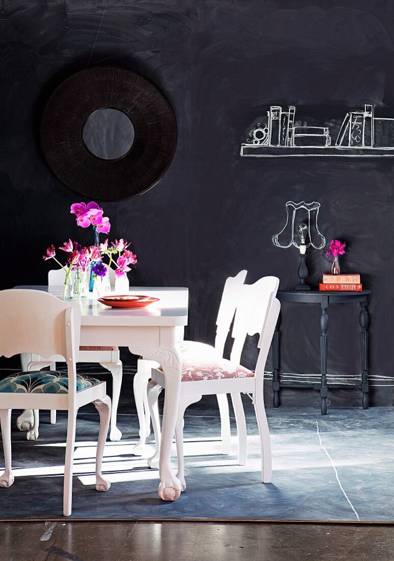 Home accessories painted on chalkboard wall as whimsical complement to white-painted period furniture
