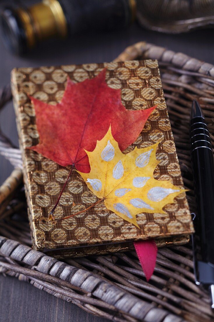 Notebook decorated with autumn leaves