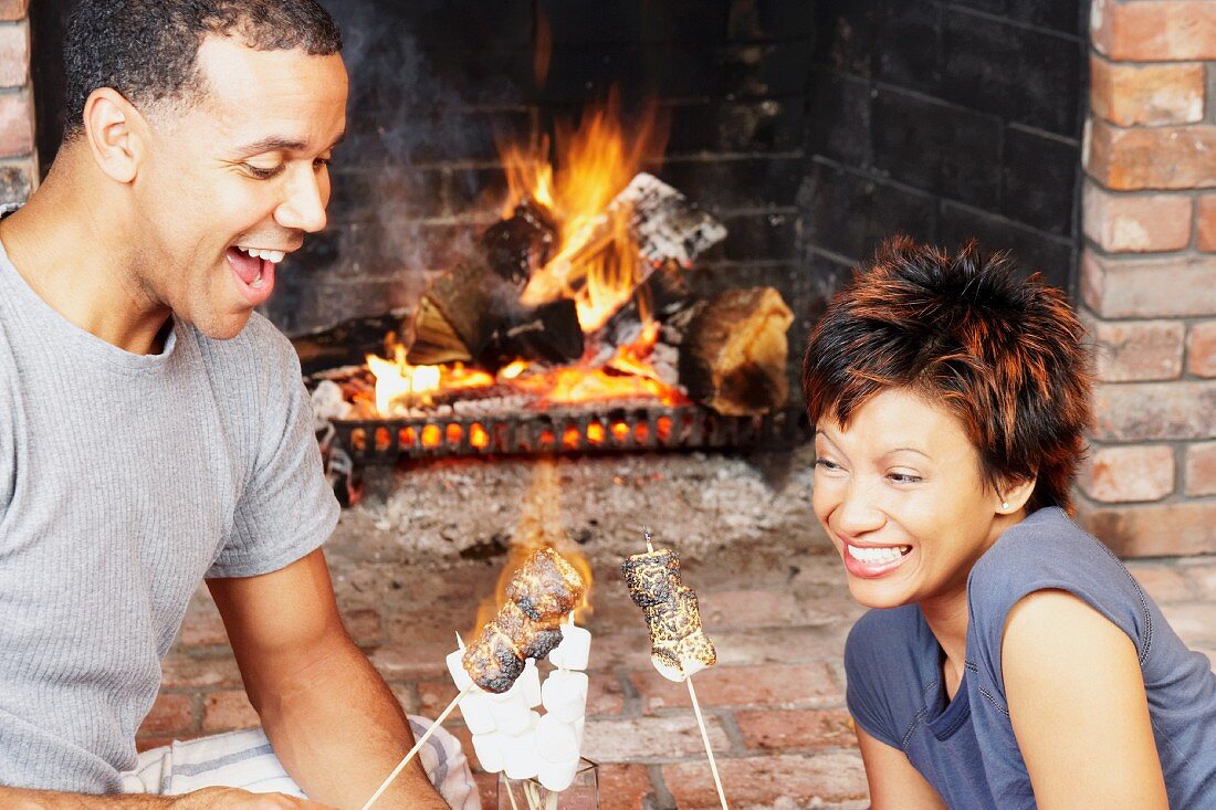Young couple toasting marshmallows