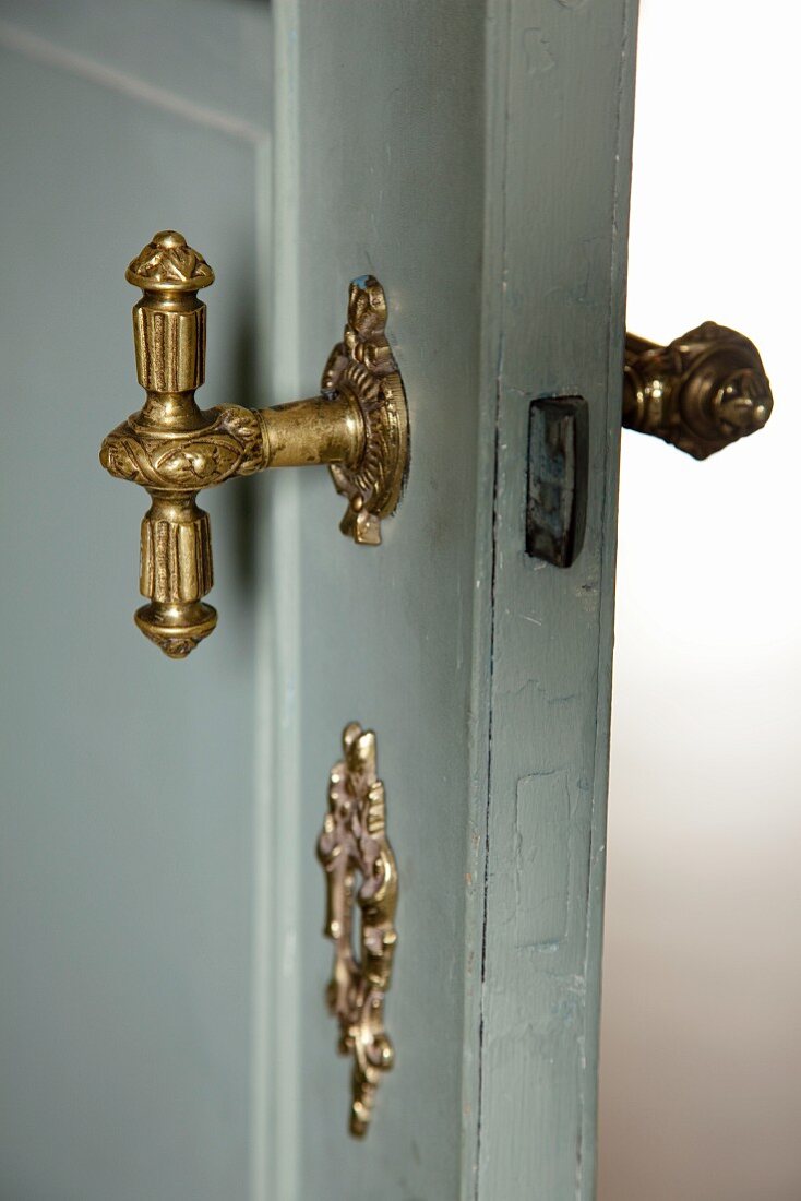 Nostalgic, hand-crafted, brass door handle on restored, 20s interior door