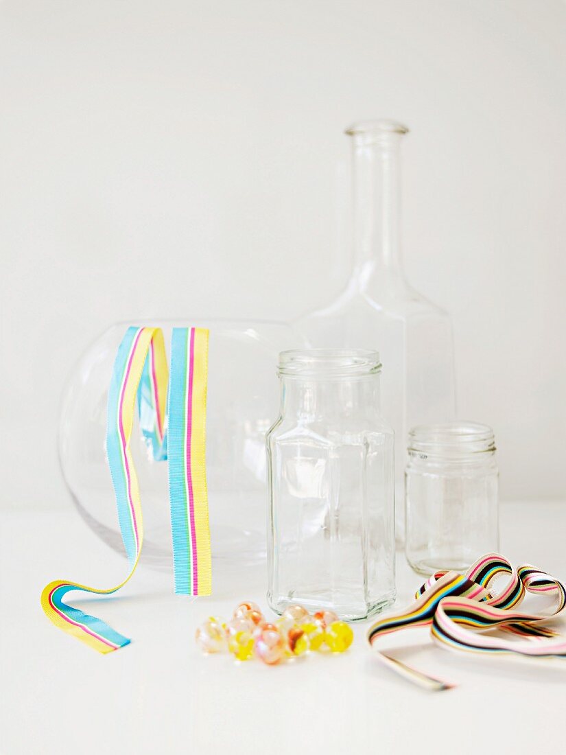Glass vessels, decorative ribbons & glass sphere for creating flower arrangements