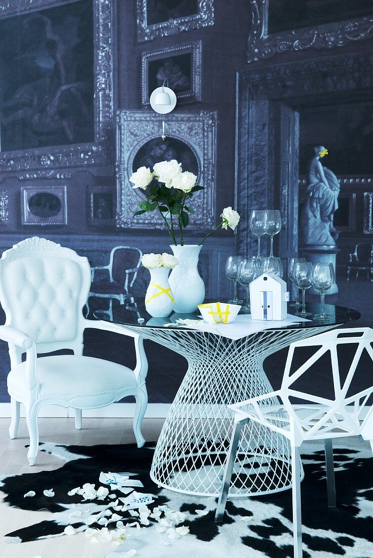 Modern, metal lattice chair and white, postmodern armchair at table with wedding symbols on top