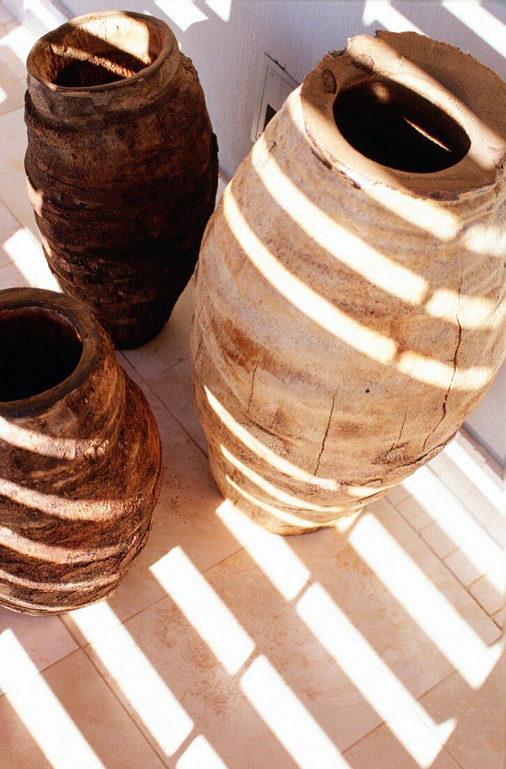 Pattern of light and shadow on primitive ceramic vases