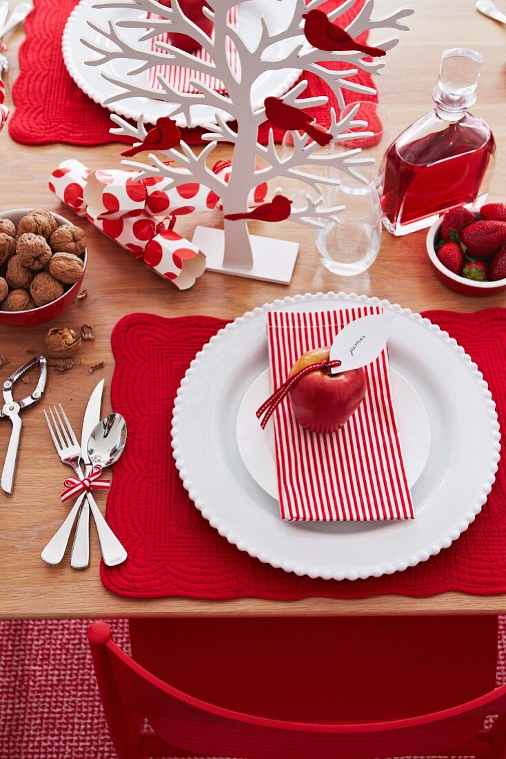 Red and white Christmas place setting with miniature tree ornament