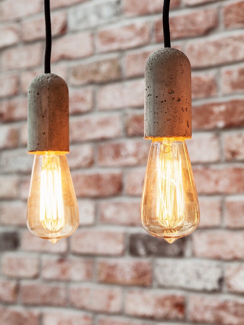 Simple pendant lamps with exposed light bulbs and concrete sockets
