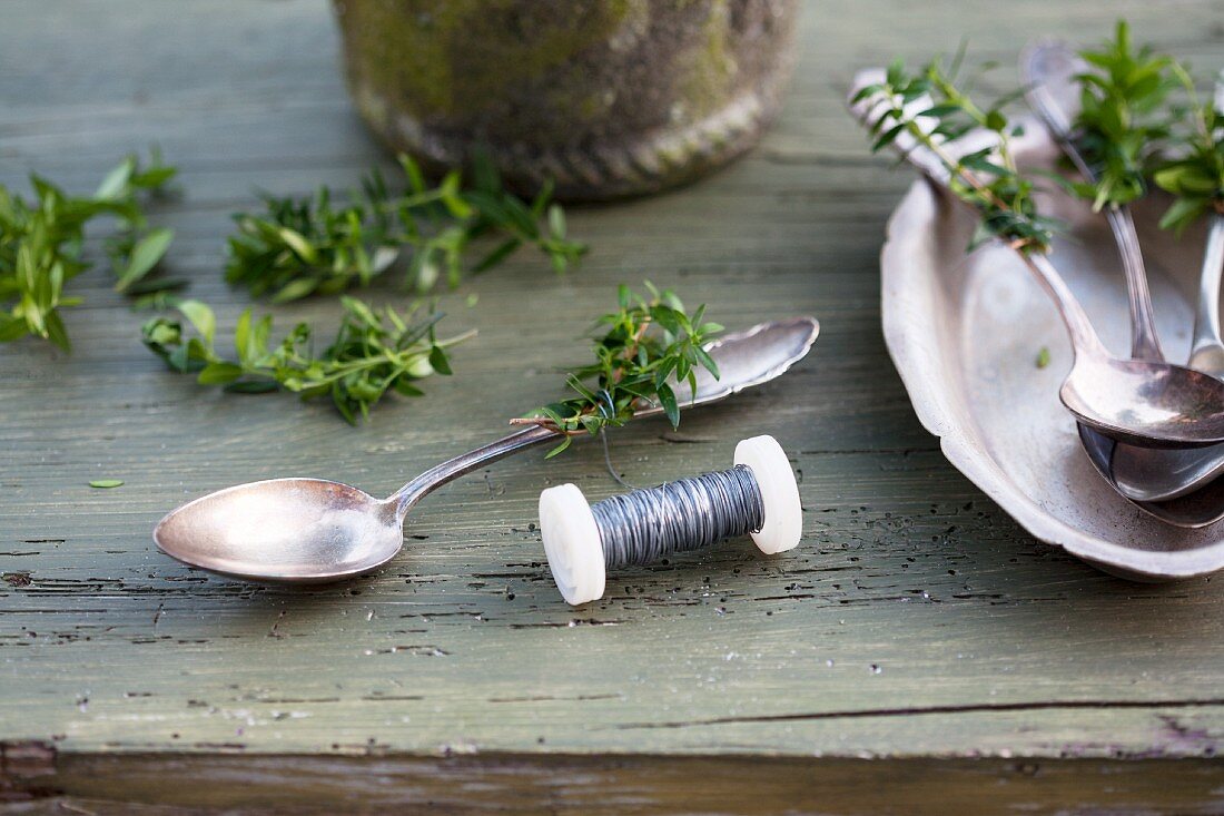 Tying sprigs of myrtle to silver spoons