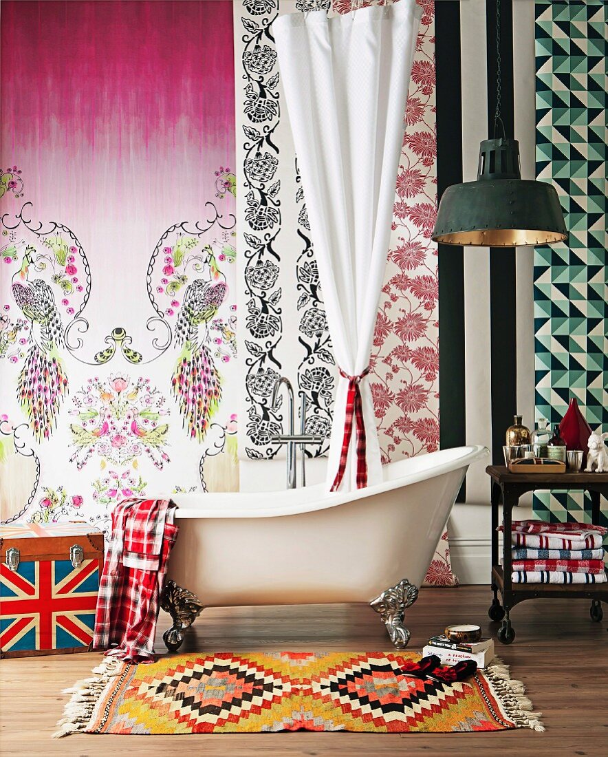 Bathroom arrangement - ethnic rug in front of vintage bathroom and wall covered in sections of different patterned wallpapers