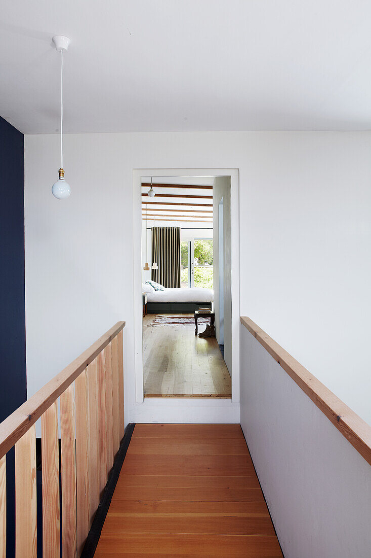 Narrow hallway on the upper floor, view into the bedroom