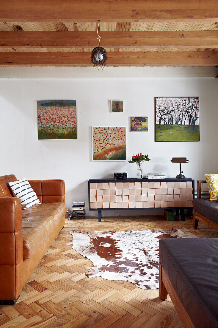 Living room with wooden beamed ceiling and leather couch