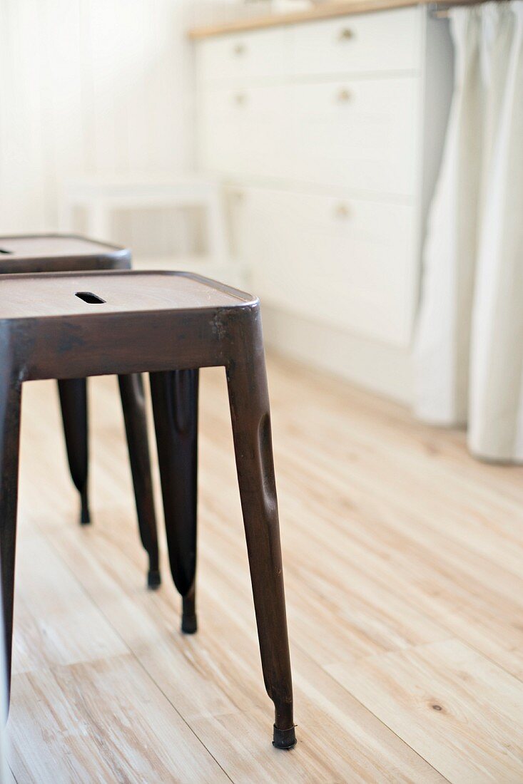 Classic metal stools on wooden kitchen floor