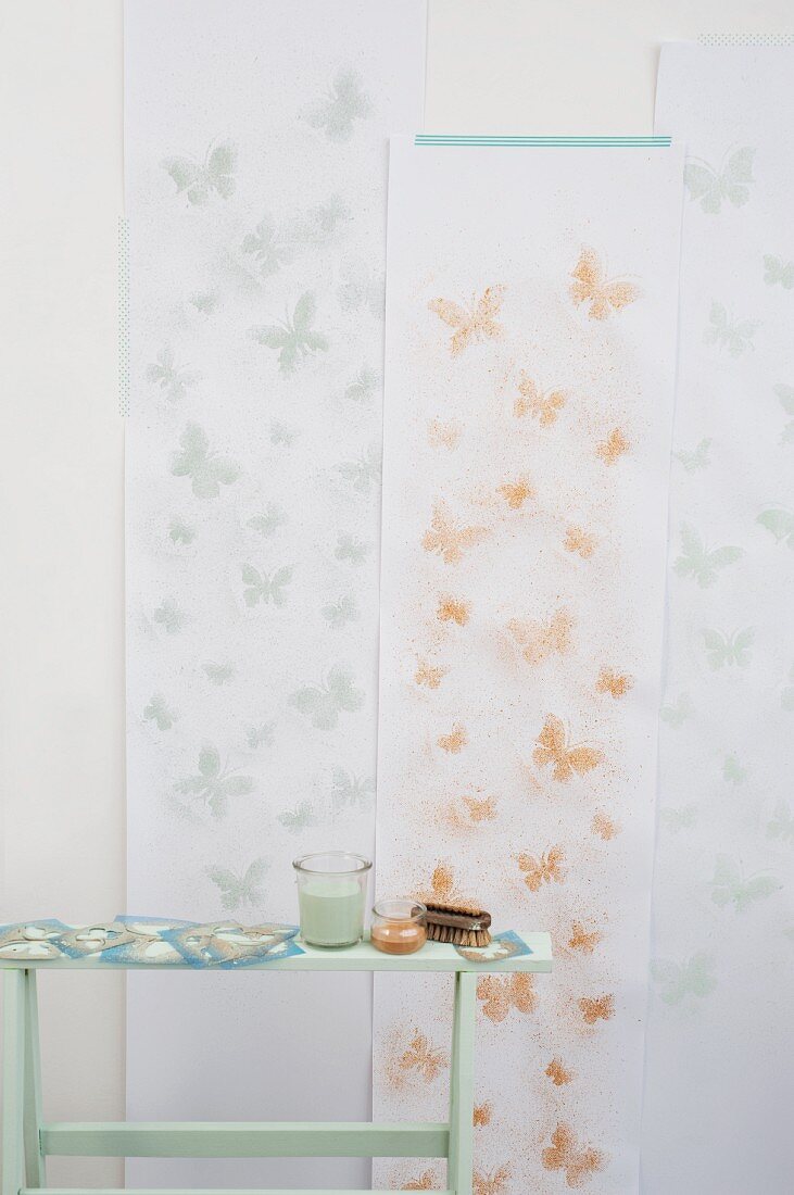 Wallpaper decorated with stencilled butterflies