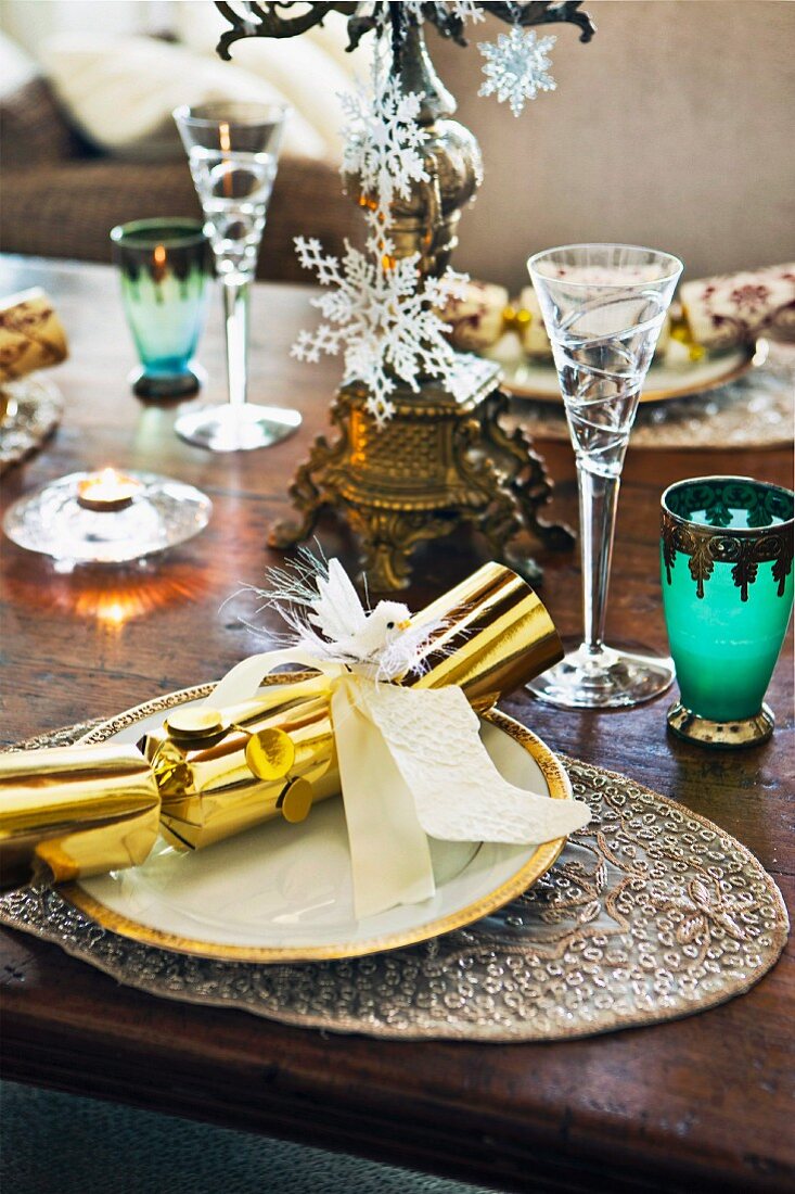 Festively set dinner table with Christmas crackers on plates