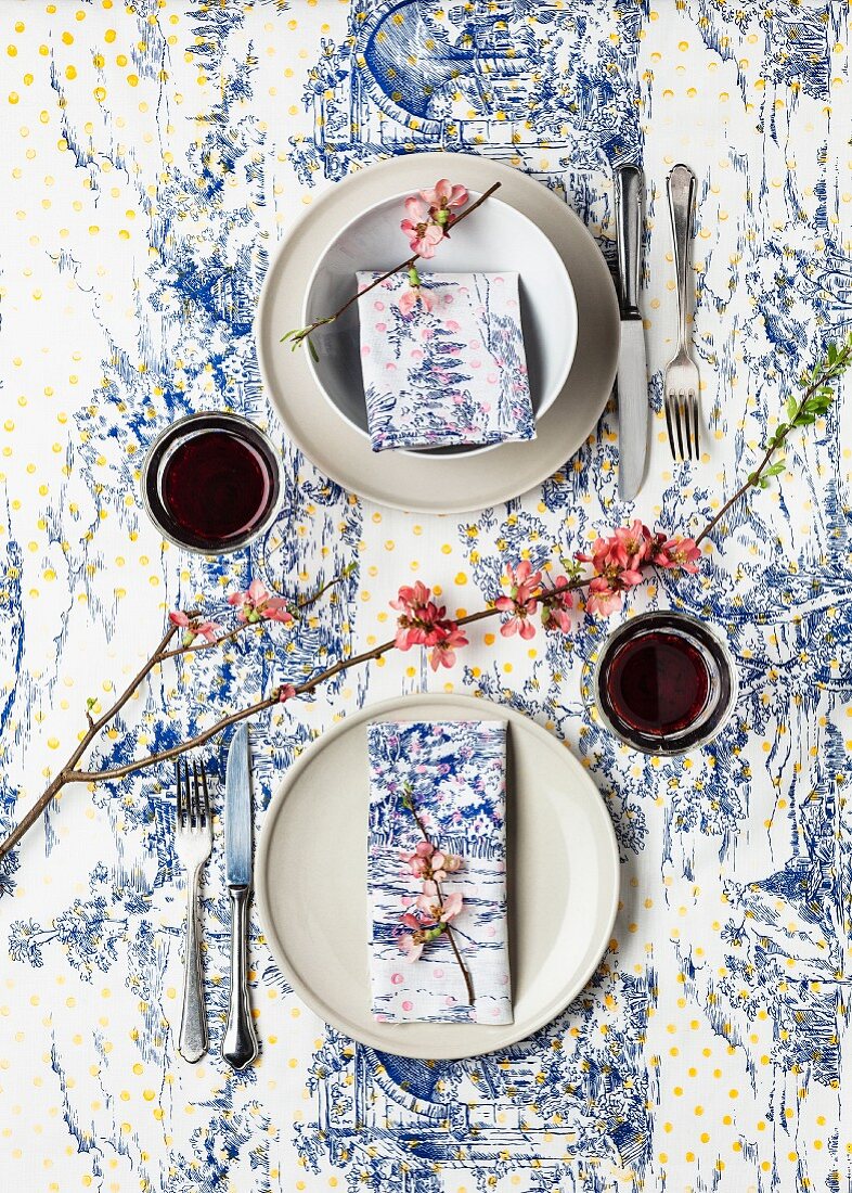 Table set for two - toile de jouy tablecloth and napkins hand-printed with additional colourful polka-dots
