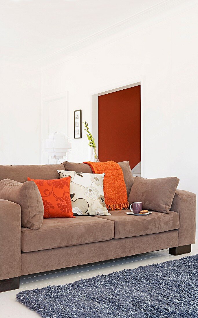 Brown, multifunctional sofa bed with scatter cushions